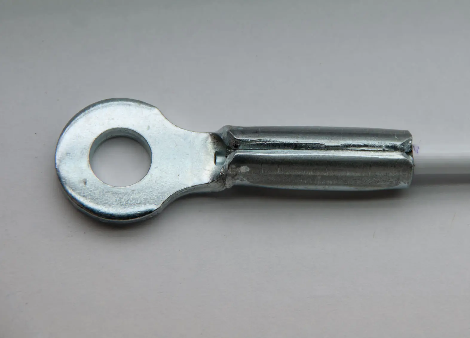 Crimped Stamped eye coated cable on white background