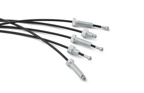 Exercise machine cables spinning bolt group Group of exercise machine style control cables with threaded ends and fittings.