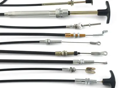 Multiple push-pull control cables lined up with different end fittings and handles.