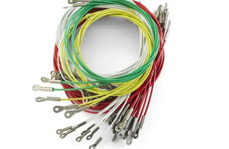 Colored stamped eye cable bundle Large bundle of colored cable assemblies with metal eye ends on a light background.