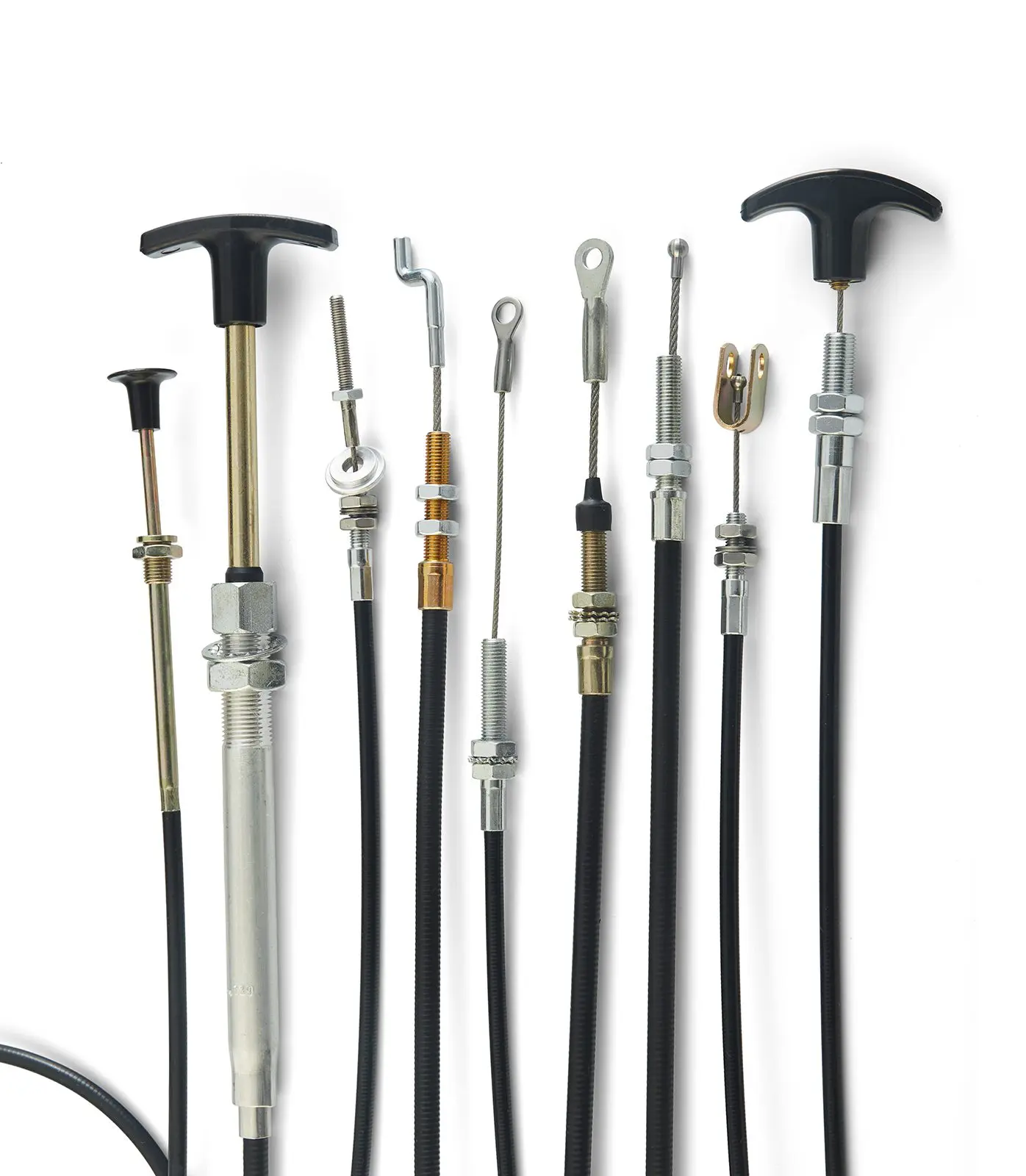 Multiple push-pull control cables lined up with different end fittings and handles.